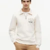 Camisola polo com fecho de correr de um quarto e logótipo floral Camisola polo com fecho de correr de um quarto e logótipo floral