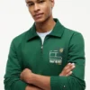 Camisola polo com fecho de correr de um quarto e logótipo floral Camisola polo com fecho de correr de um quarto e logótipo floral