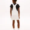 Vestido-macacão em Hilfiger Denim com emblema Hilfiger para criança Vestido-macacão em Hilfiger Denim com emblema Hilfiger para criança