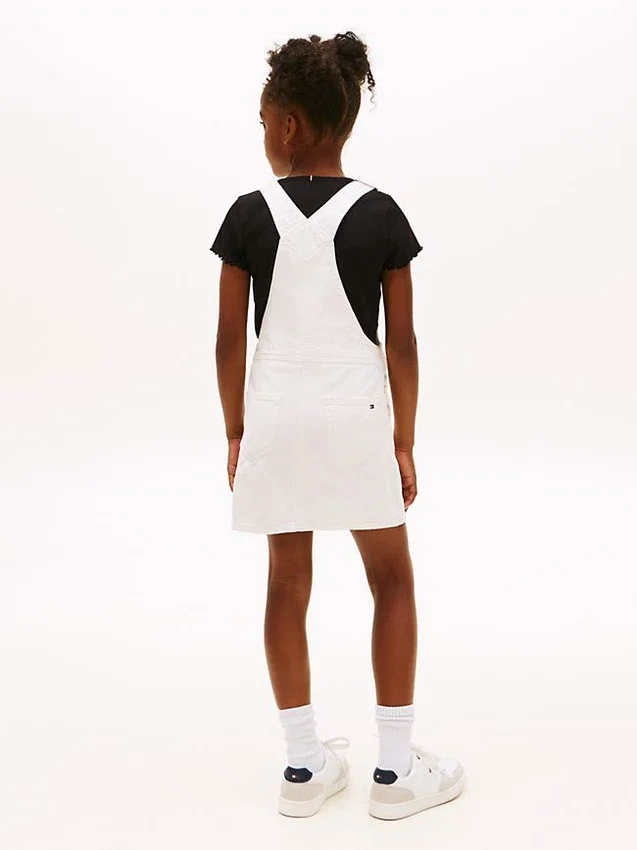 Vestido-macacão em Hilfiger Denim com emblema Hilfiger para criança Vestido-macacão em Hilfiger Denim com emblema Hilfiger para criança